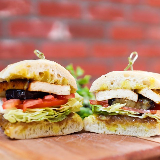 Our monthly special sandwich is scrumptious AND meatless: roasted tofu, confit onions, curry mayo, seasoned eggplant, tomato and lettuce on…